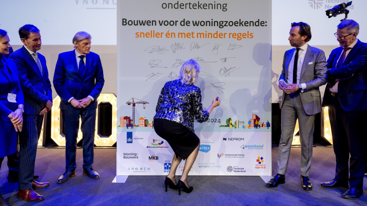 Minister Mona Keijzer van Volkshuisvesting ondertekent tijdens de woontop van december de gemaakte afspraken.