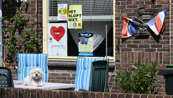 Woning complotdenker in Tilburg: posters, omgekeerde vlaggen